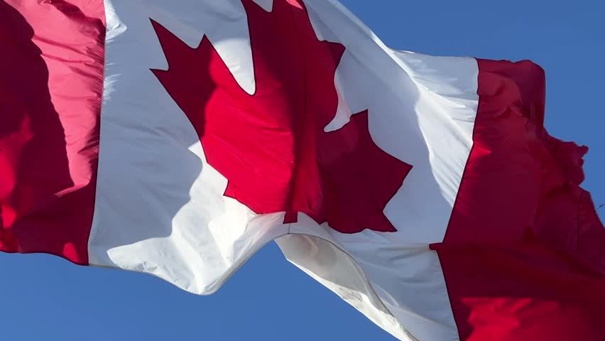 Canadian Flag Fluttering Against Blue Sky | Editorial Video | 13767047e ...